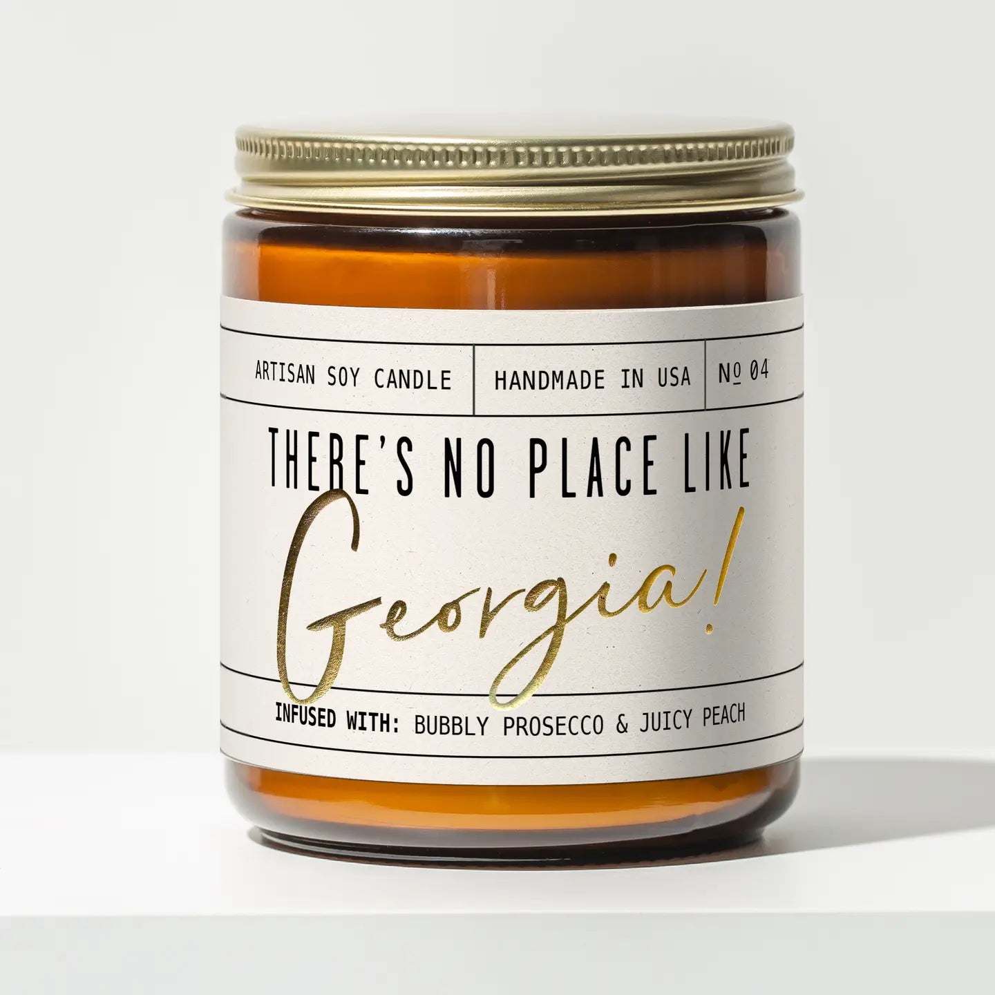Candle with a label reading 'There's no place like Georgia!' on a white background