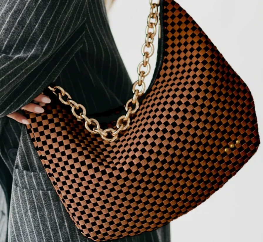A brown and black checkered hobo bag featuring a thick, gold-tone chain-link shoulder strap and subtle gold hardware accents.