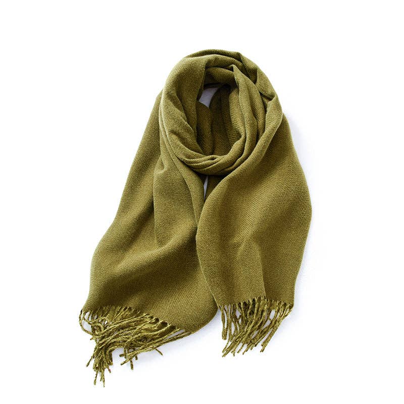 Green scarf loosely looped on a white background, with twisted fringe at both ends.