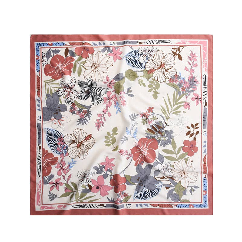 Square ivory shawl with red, pink and gray flowers, green leaves and a red border, laid flat.