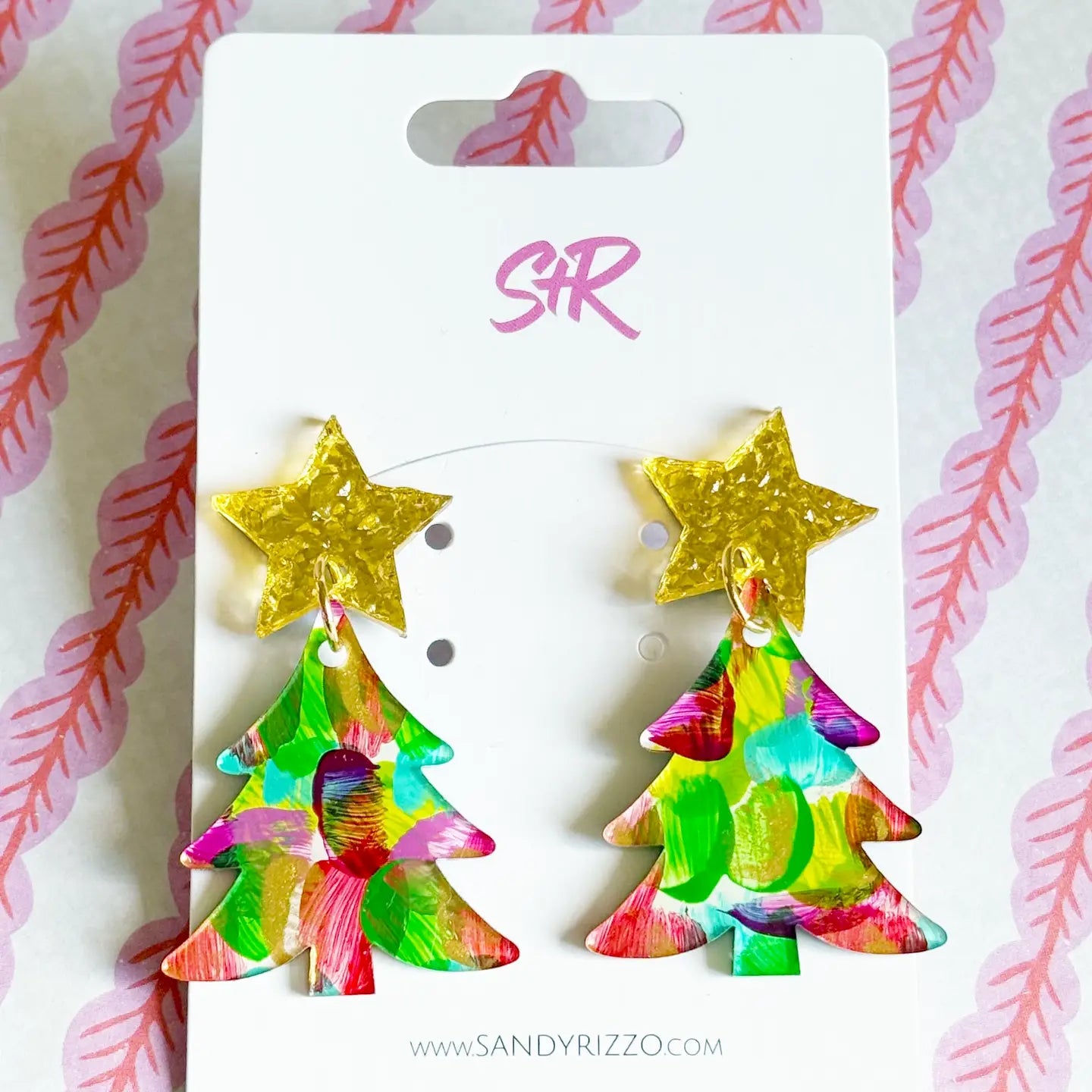 A pair of holiday-themed drop earrings featuring textured gold bow posts and colorful, hand-painted bulb-shaped dangles with vibrant green, red, and pink brushstrokes.