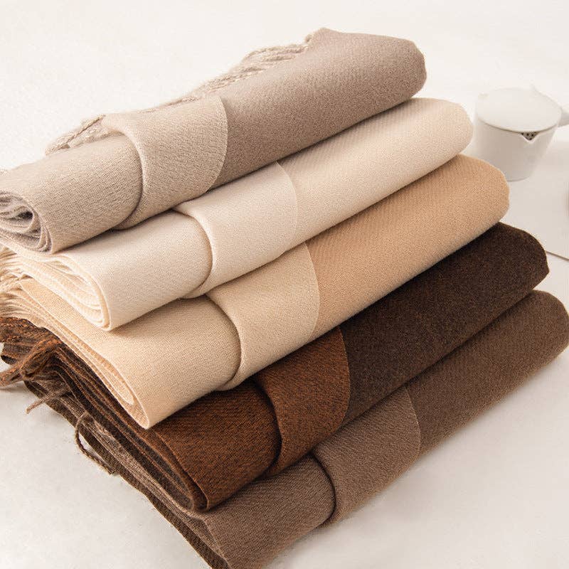 Folded fringed scarves in taupe, cream and brown at Dover Grace Boutique in Watkinsville, Georgia.