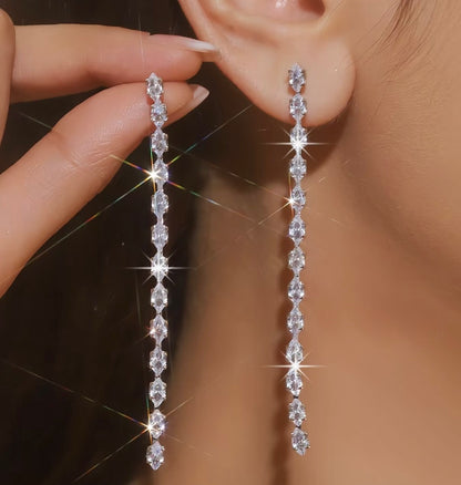 Long silver earrings with a vertical line of marquise-cut crystal stones.