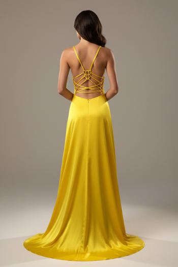 Yellow evening gown with intricate back design on a neutral background