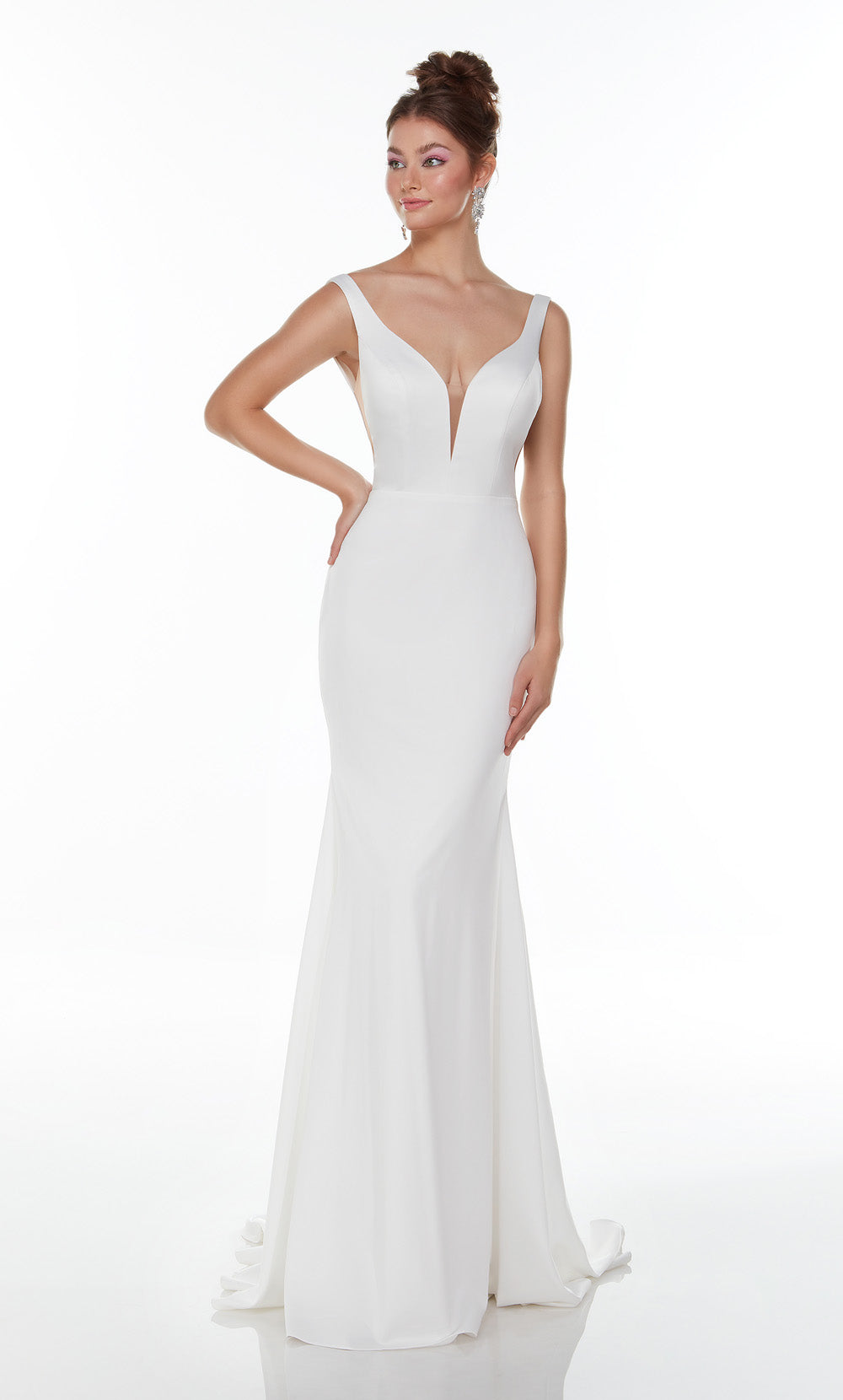 Front view of a model wearing a fitted sleeveless white gown with a deep plunging V-neckline and a flared mermaid-style skirt.