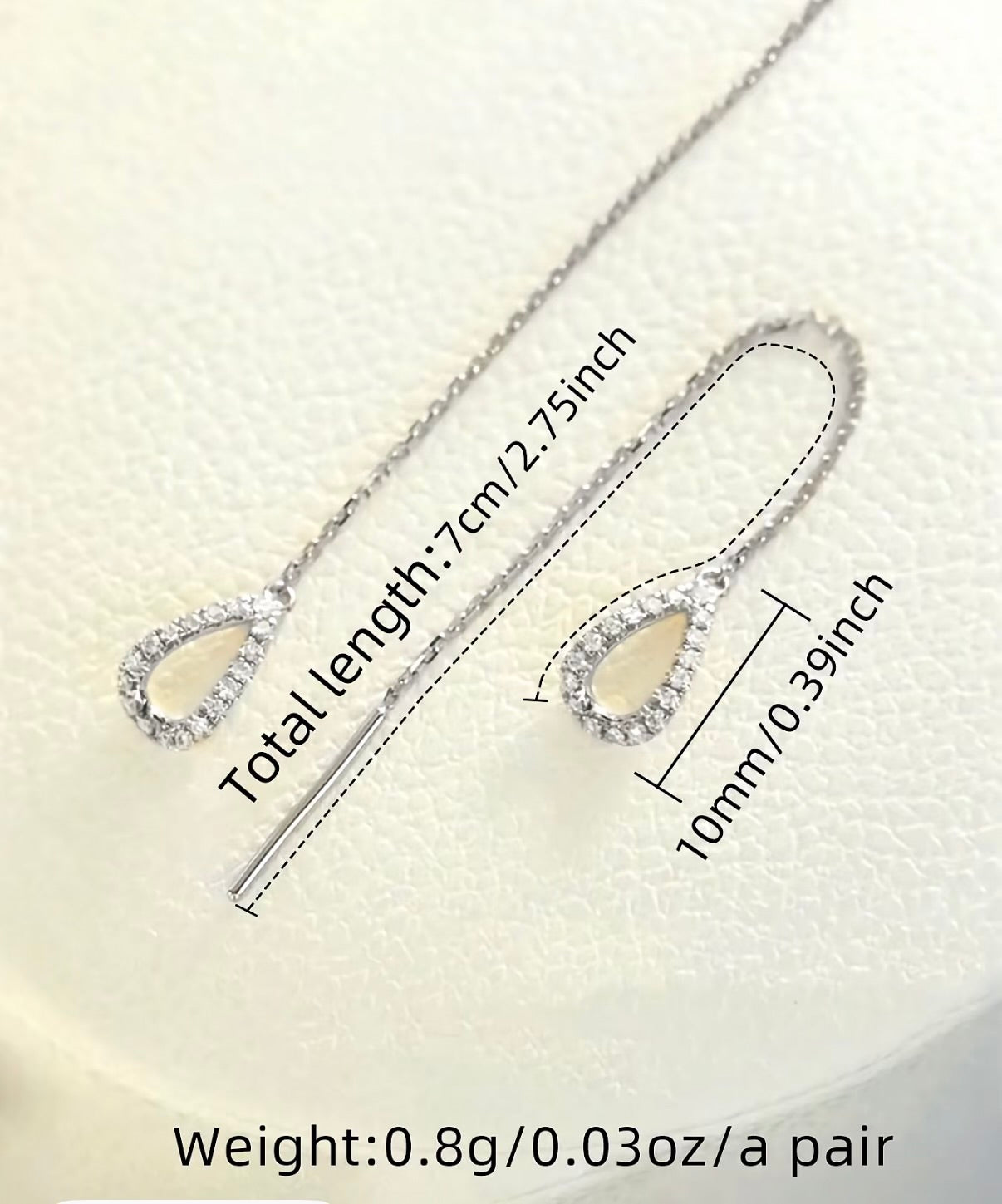 Silver chain threader earrings with a single crystal teardrop on each end.