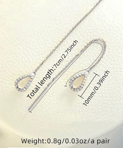 Silver chain threader earrings with a single crystal teardrop on each end.