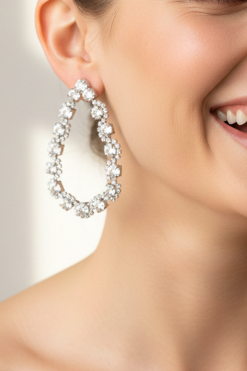 A pair of shimmering, teardrop-shaped hoop earrings encrusted with brilliant-cut diamonds