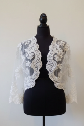 White lace shrug on a black mannequin against a white background