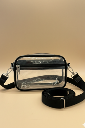 A rectangular, transparent PVC crossbody bag featuring structured black trim and a top zipper with silver hardware. It includes a detachable, wide black adjustable strap with silver-toned metal clasps.