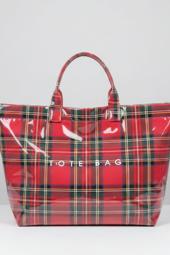 A glossy, red tartan plaid tote bag with a reflective finish, featuring the words 