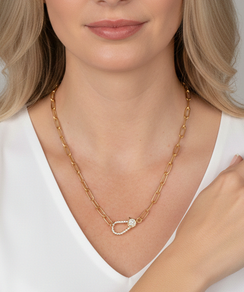 Gold paperclip link necklace featuring a carabiner clasp encrusted with clear pavé crystals.