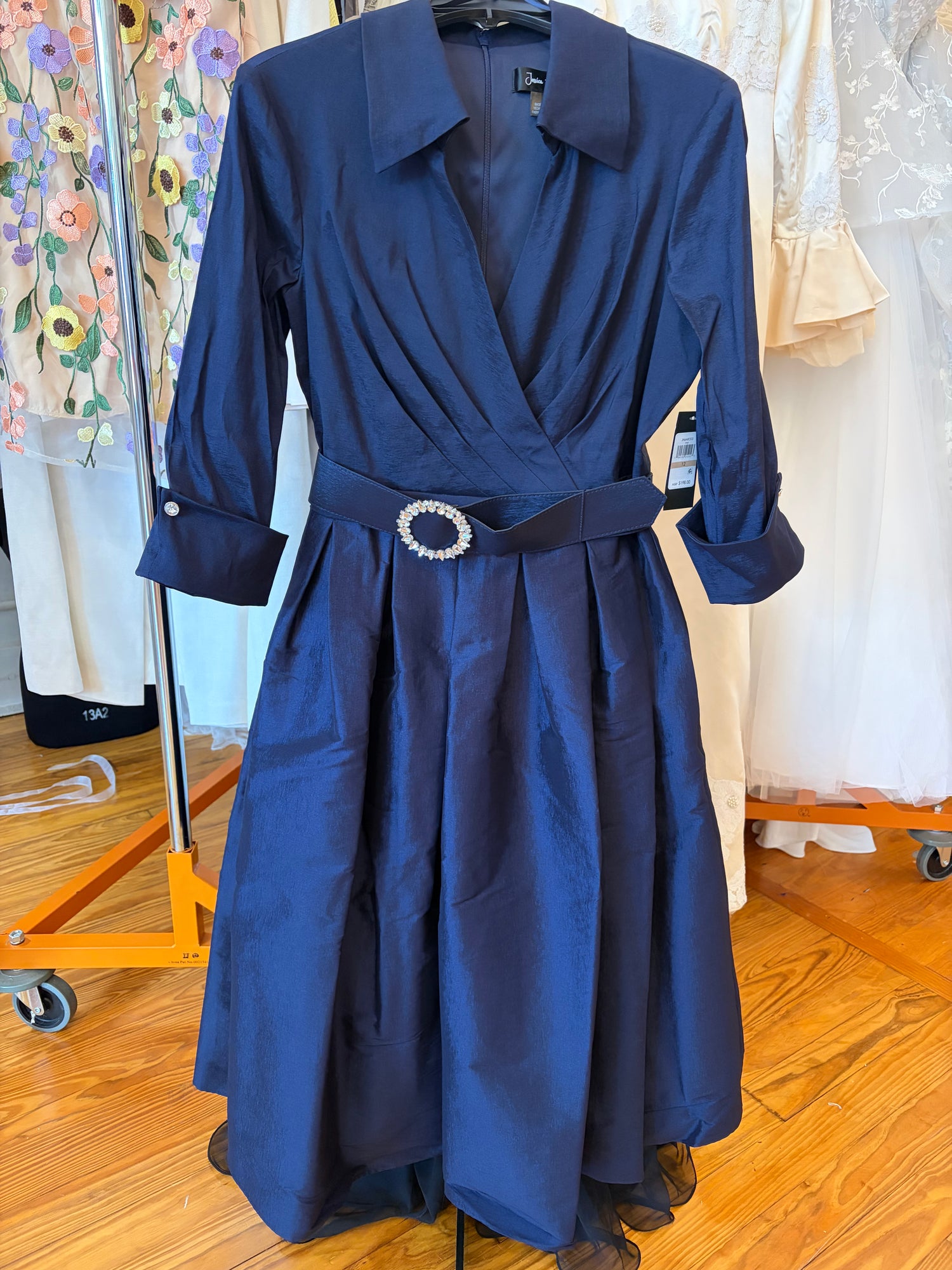 Jessica Howard JH6M8203 navy wrap midi dress with jeweled belt – front view on dress form