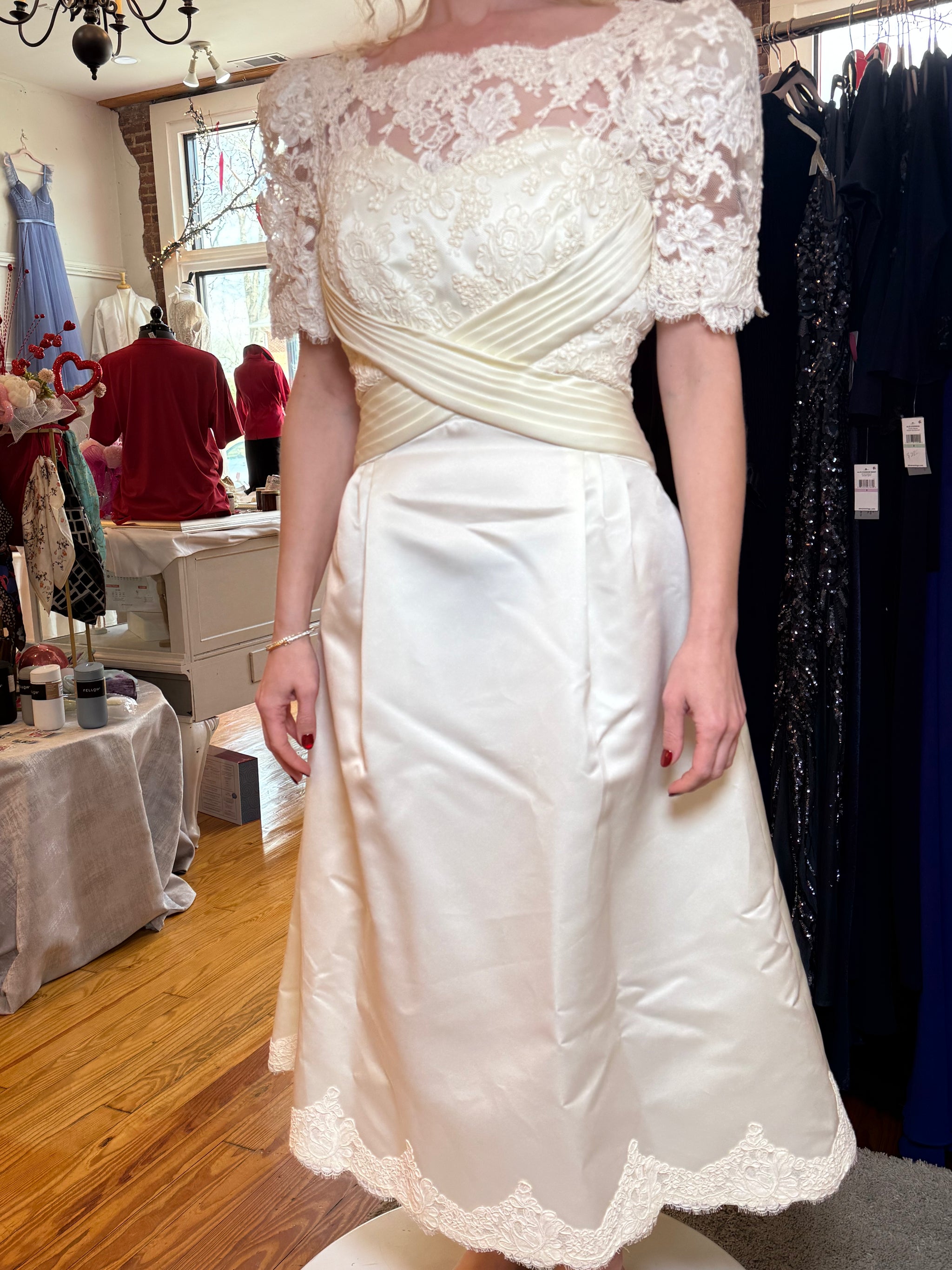 White lace dress on a mannequin in a clothing store setting