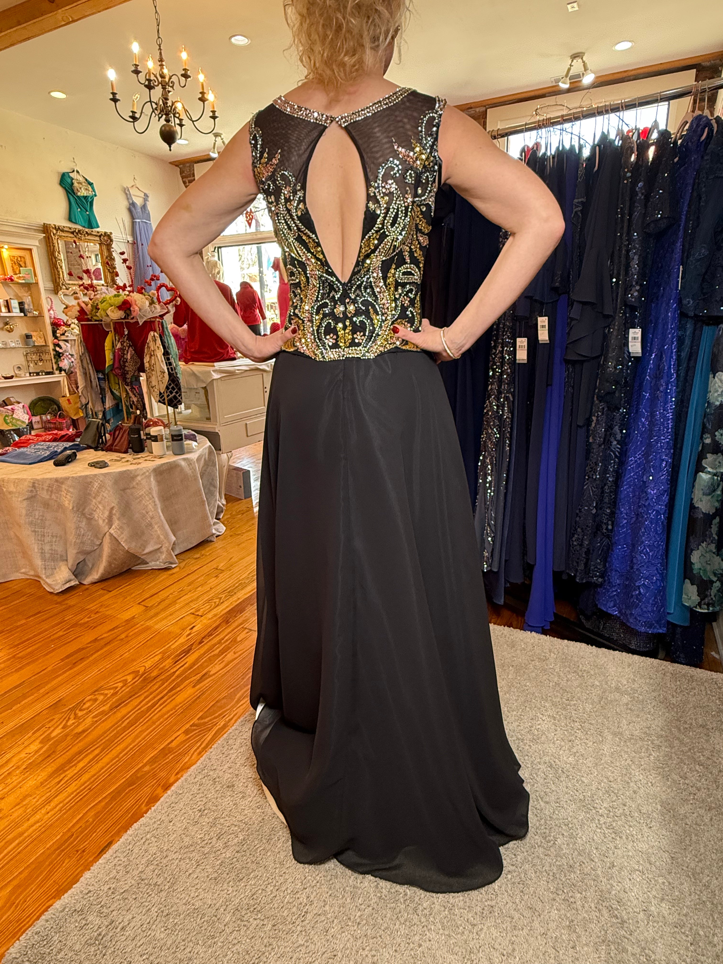 Woman wearing a black evening gown with an open back in a clothing store.