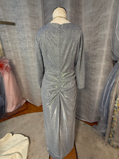 Silver metallic lurex evening gown, back view, showing gathered bow detail at center back, three-quarter sleeves, and floor-length column skirt with button closure