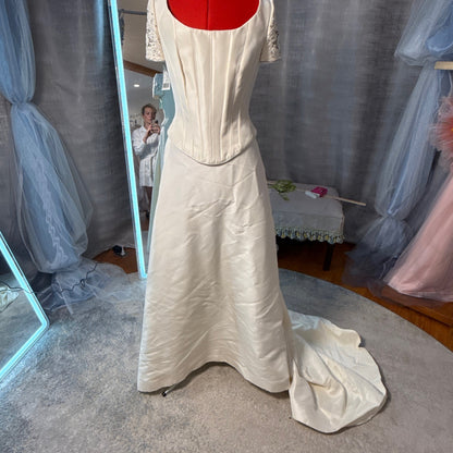 Pronovias vintage 2-piece ivory mikado wedding gown, front view showing structured boned corset top with short lace sleeves, scoop neckline, and full A-line skirt with train, size 14, new with tags
