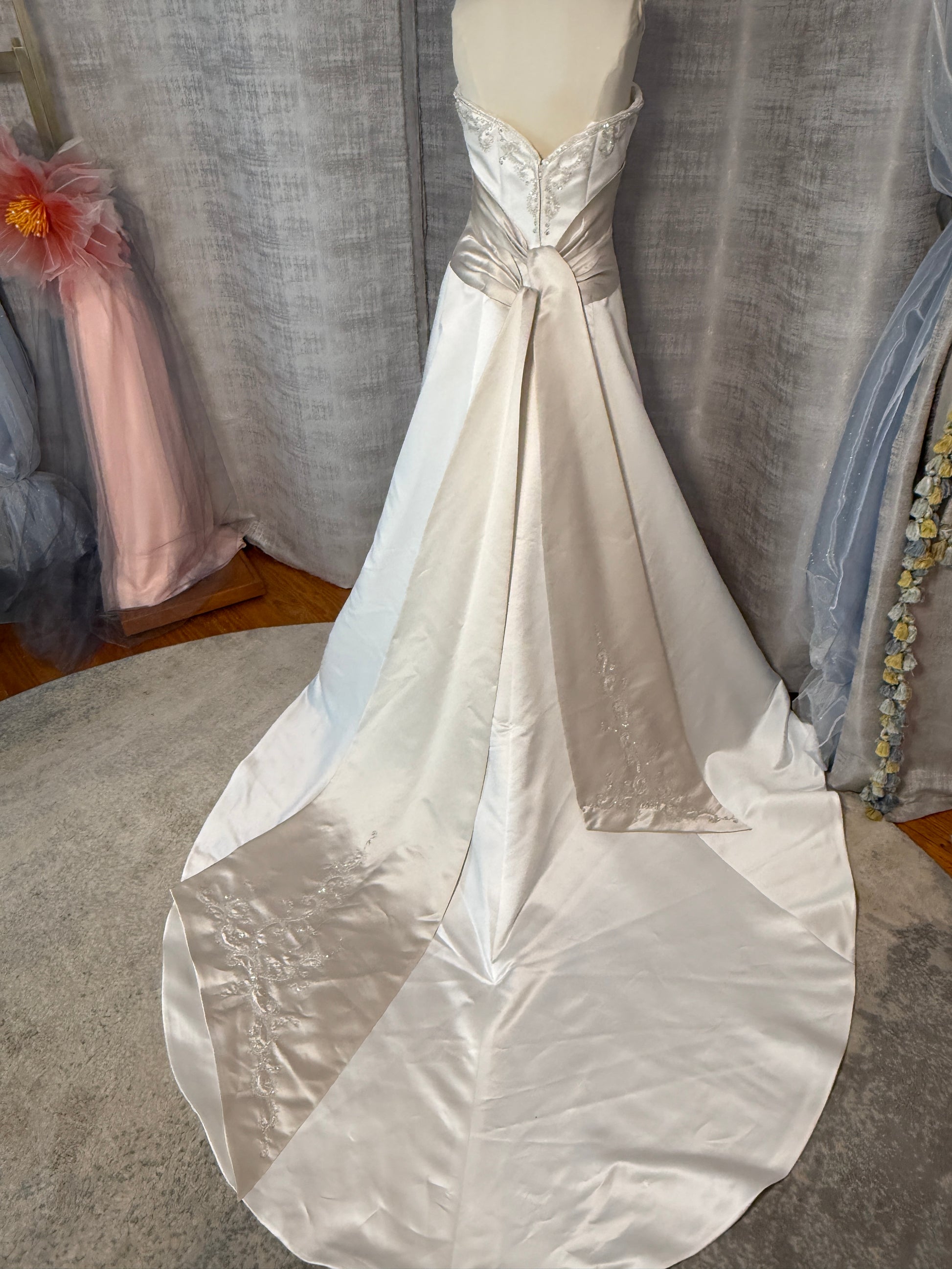 Mon Cheri vintage satin ballgown back view showing contrast champagne sash panel, sweetheart back bodice with silver beading, and full cathedral-length train with embroidered hem detail