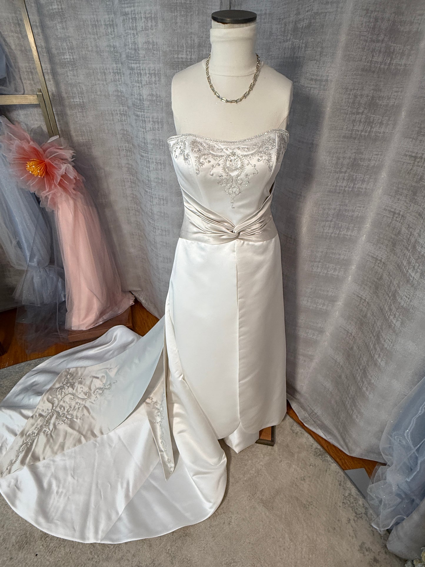Mon Cheri vintage ivory satin ballgown, front view showing strapless sweetheart neckline with silver beaded scrollwork bodice, contrast champagne ruched sash, and cathedral train with embroidery, size 6