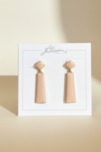 Blush pink geometric drop earrings with gold-tone trim on a branded display card.