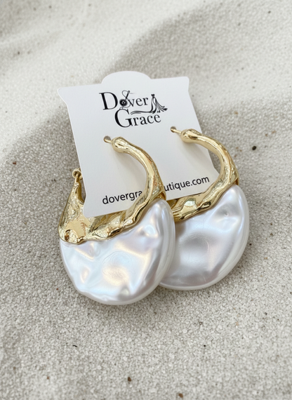 Teardrop hoop earrings with a textured molten gold-tone upper half and a sculpted iridescent pearl lower half.
