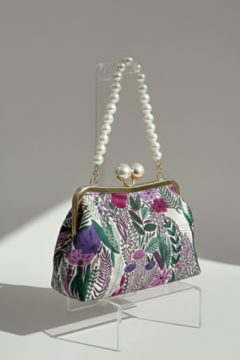 Trapezoidal frame clutch with a botanical tapestry of magenta flowers and green leaves. It features a gold-tone clasp with two pearl baubles and a matching large pearl strand handle.