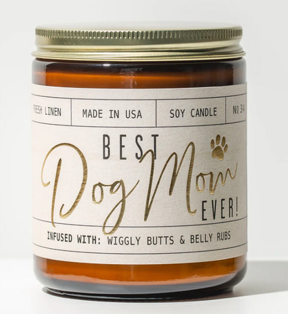 
An amber glass soy candle with a gold lid and a cream label featuring "Best Dog Mom Ever!" in black and gold script with a small gold paw print.