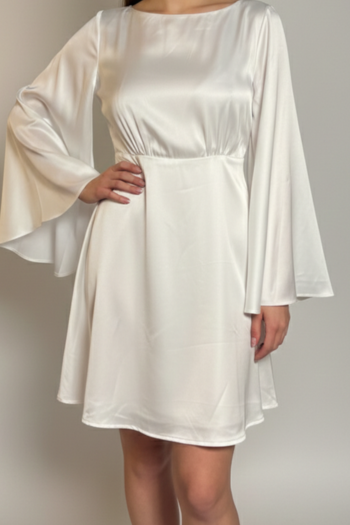 White dress with bell sleeves on a plain background