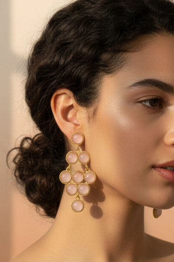Gold-tone chandelier earrings with multiple tiered round translucent pink cabochon stones in a geometric drop.
