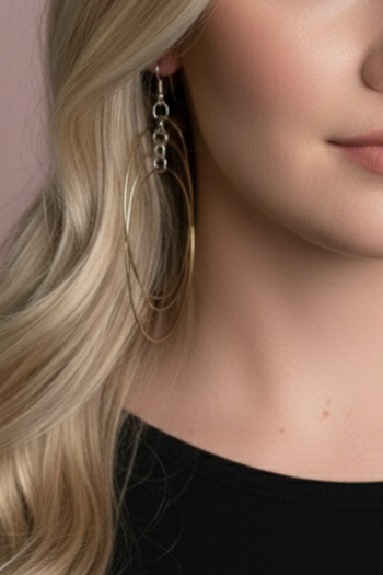 Earrings with three thin gold hoops suspended at tiered heights from a vertical silver chain.