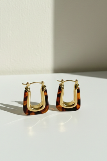 Vintage-inspired U-shaped drop earrings in brown and gold resin with a metallic gold center.