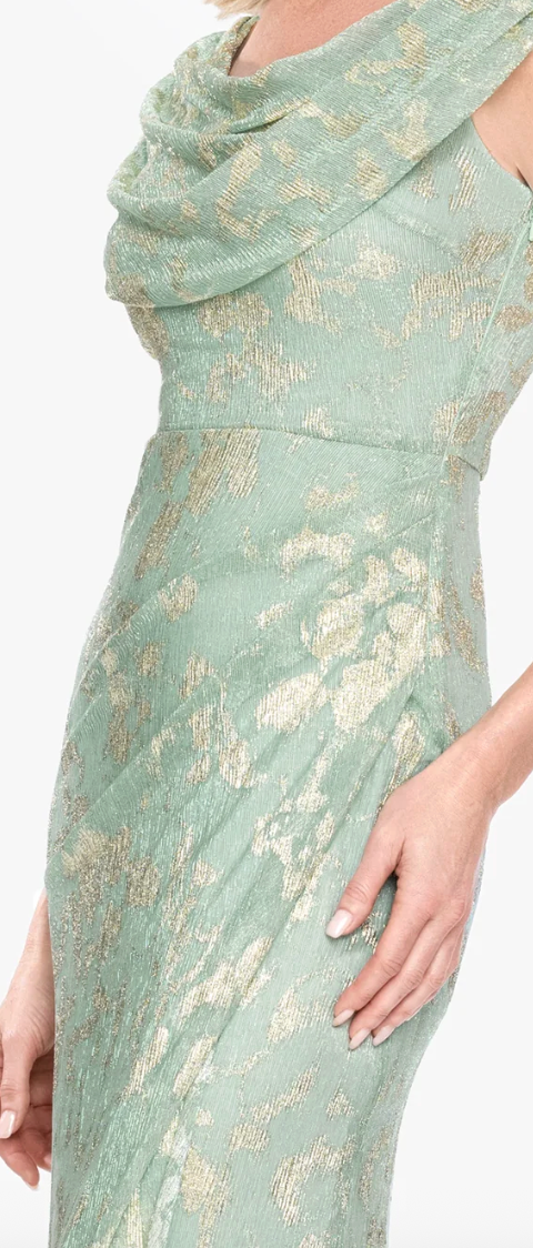 Close-up of gold metallic floral patterns and gathered hip detail on a sage green gown.