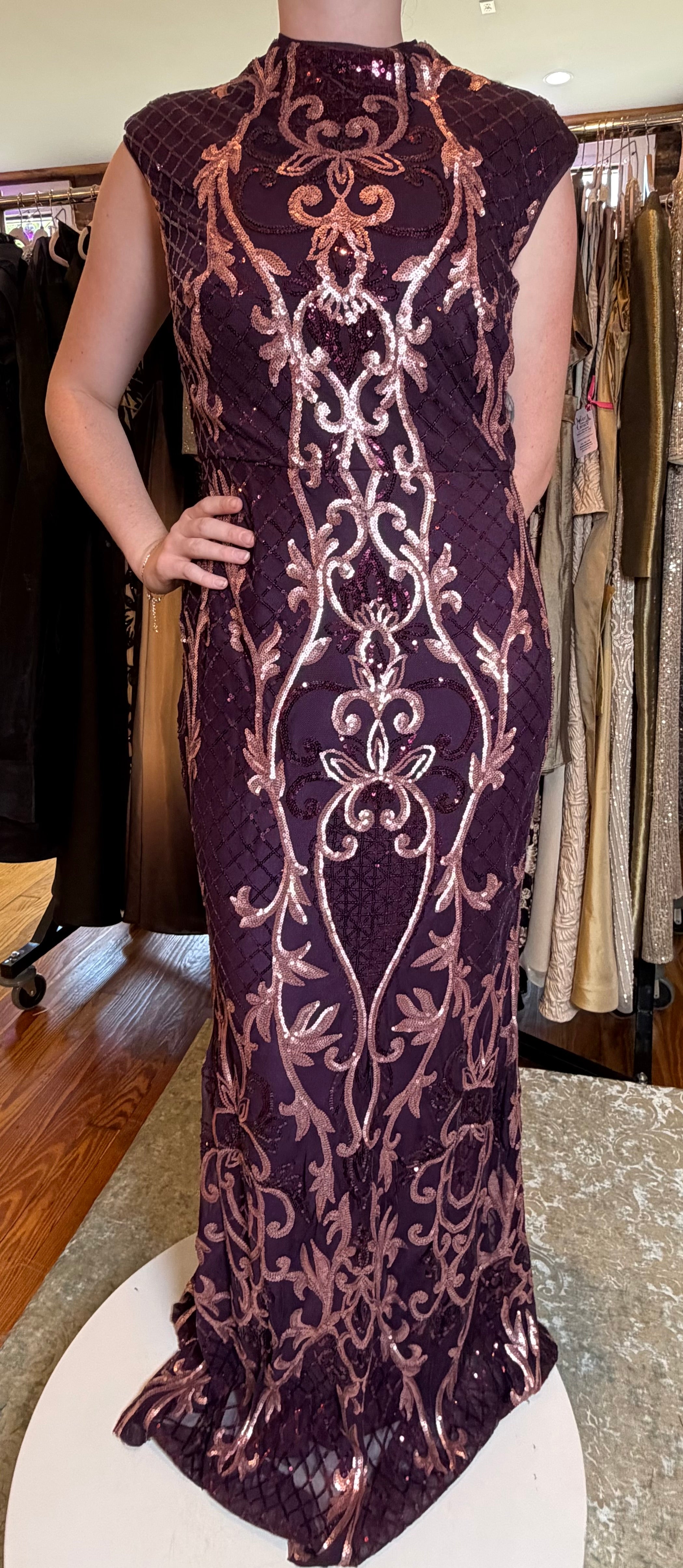 Front view of a wine evening gown with rose sequin embroidery, mock neck and cap sleeves.