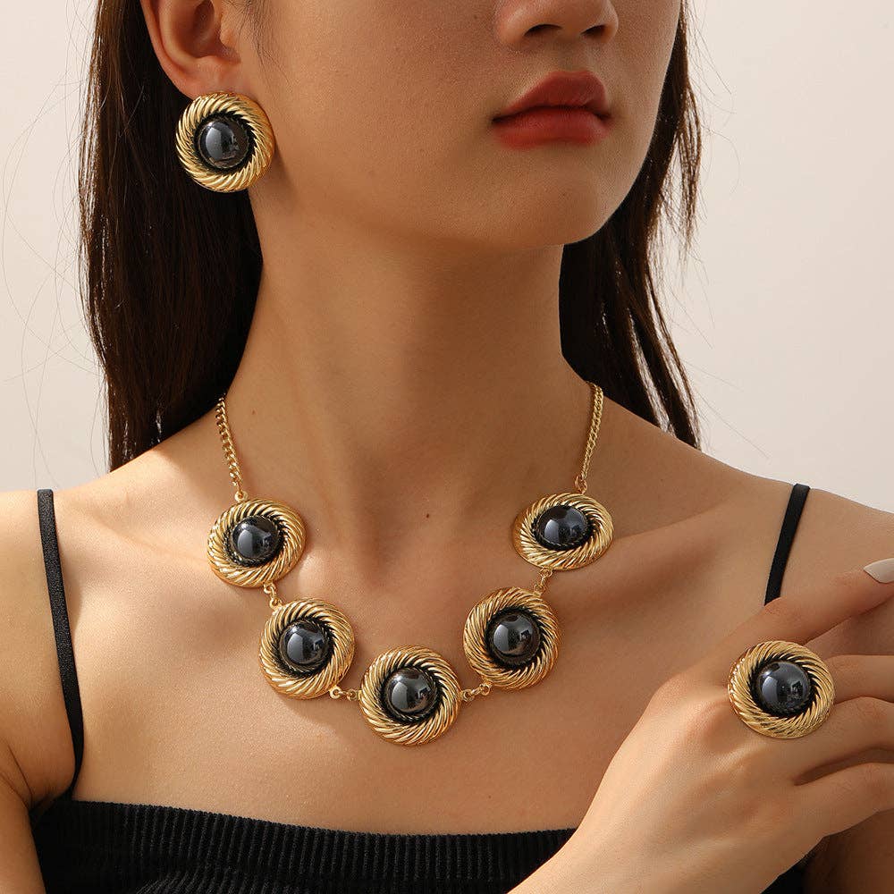 Black-center necklace, earring and ring on model at Dover Grace Boutique in Watkinsville, Georgia.