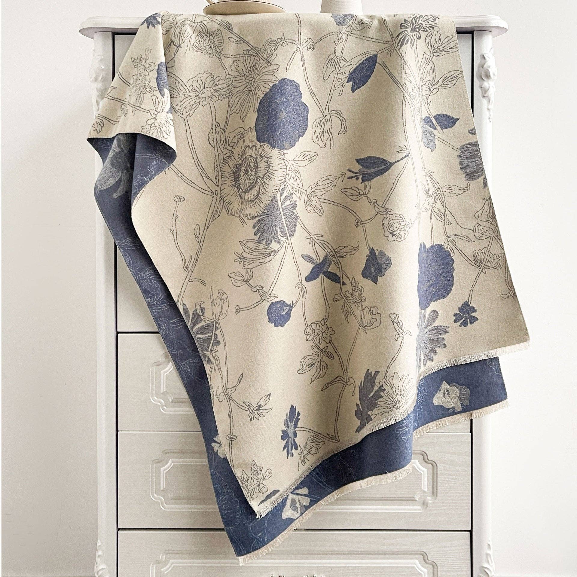 Blue and cream reversible scarf draped on chair at Dover Grace Boutique in Watkinsville, Georgia.