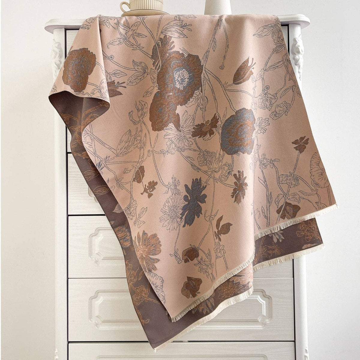 Blush printed scarf draped on chair at Dover Grace Boutique in Watkinsville, Georgia.