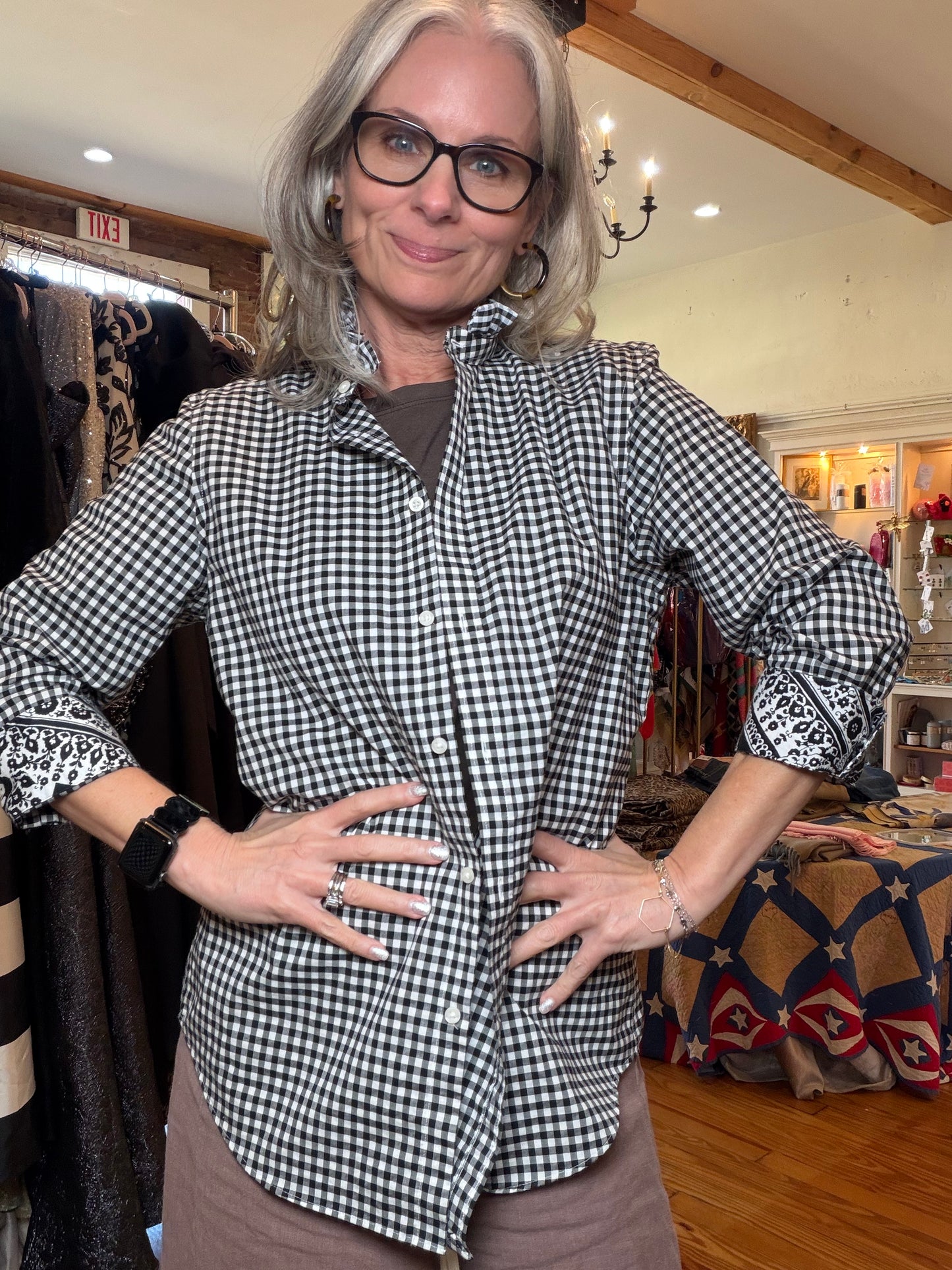 Black and white gingham shirt with a ruffle collar and rolled bandana-print cuffs.