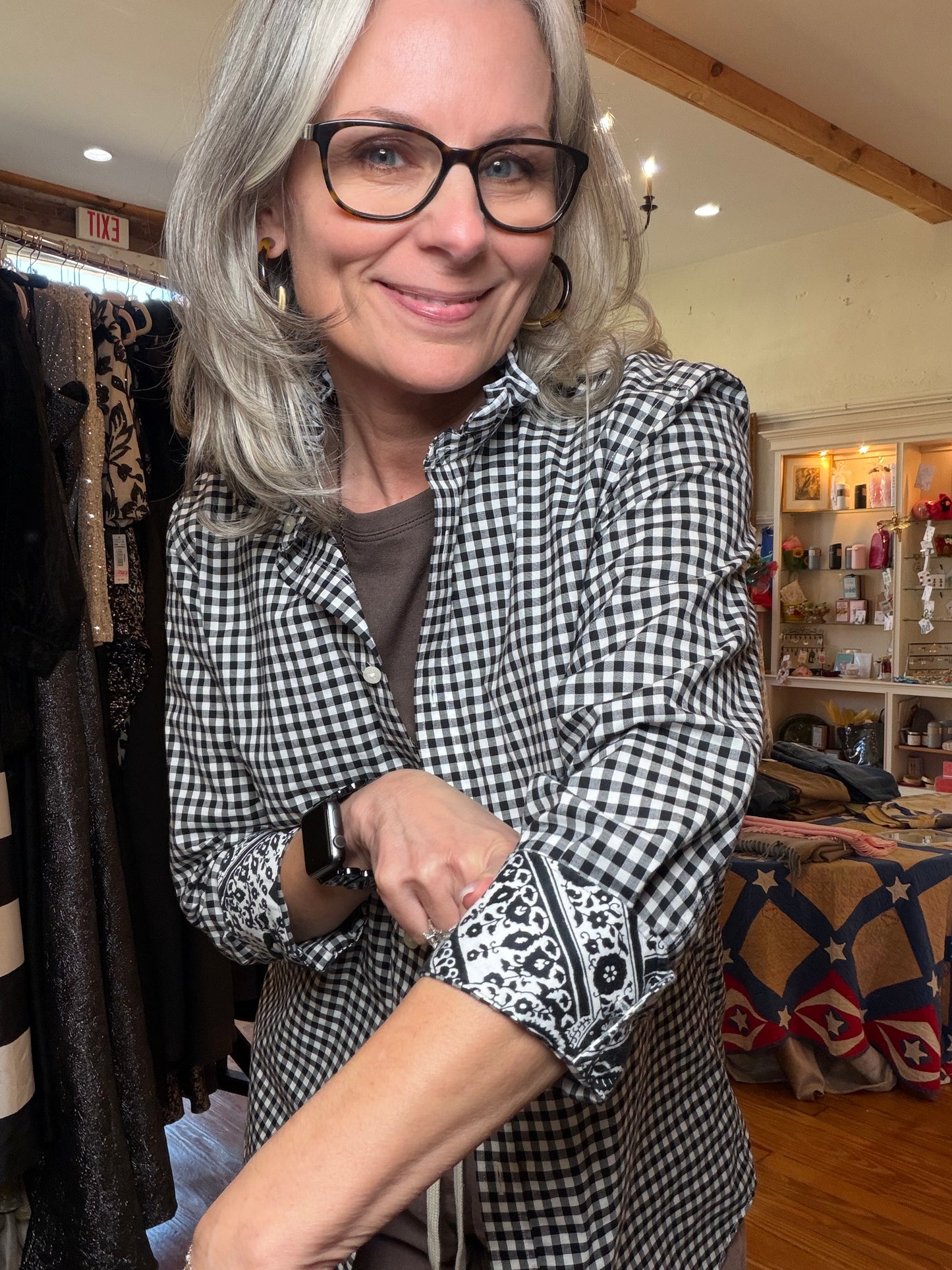 Rolled cuff showing black and white floral bandana fabric on a gingham sleeve.