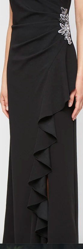 Black sleeveless stretch crepe gown with beaded hip and ruffle skirt at Dover Grace Boutique in Watkinsville, Georgia.