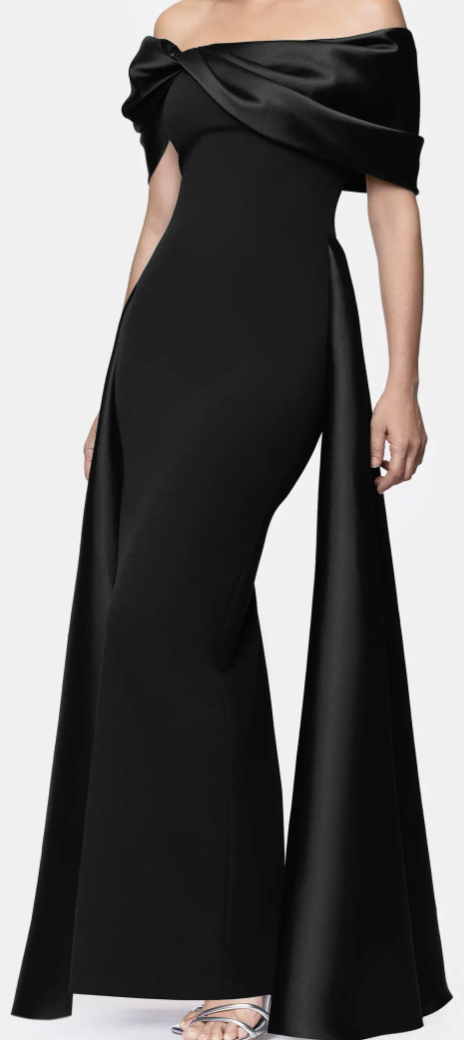 Black off-shoulder satin cape gown with pleated overlay at Dover Grace Boutique in Watkinsville, Georgia.