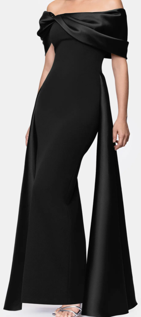 Black off-shoulder satin cape gown with pleated overlay at Dover Grace Boutique in Watkinsville, Georgia.