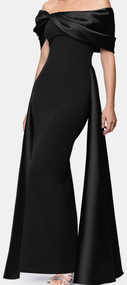 Black off-shoulder satin cape gown with pleated overlay at Dover Grace Boutique in Watkinsville, Georgia.