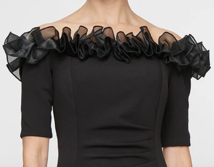 Black off-shoulder stretch crepe gown with organza ruffle neckline at Dover Grace Boutique in Watkinsville, Georgia.