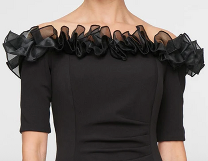 Black off-shoulder stretch crepe gown with organza ruffle neckline at Dover Grace Boutique in Watkinsville, Georgia.