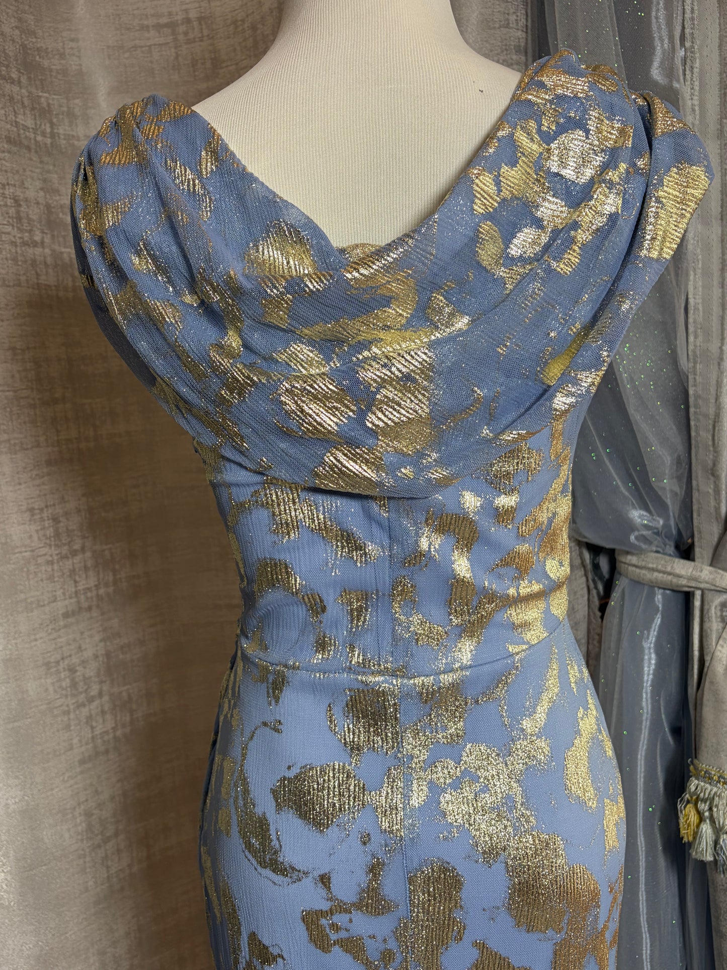 Light blue and gold metallic draped evening gown at Dover Grace Boutique in Watkinsville, Georgia.