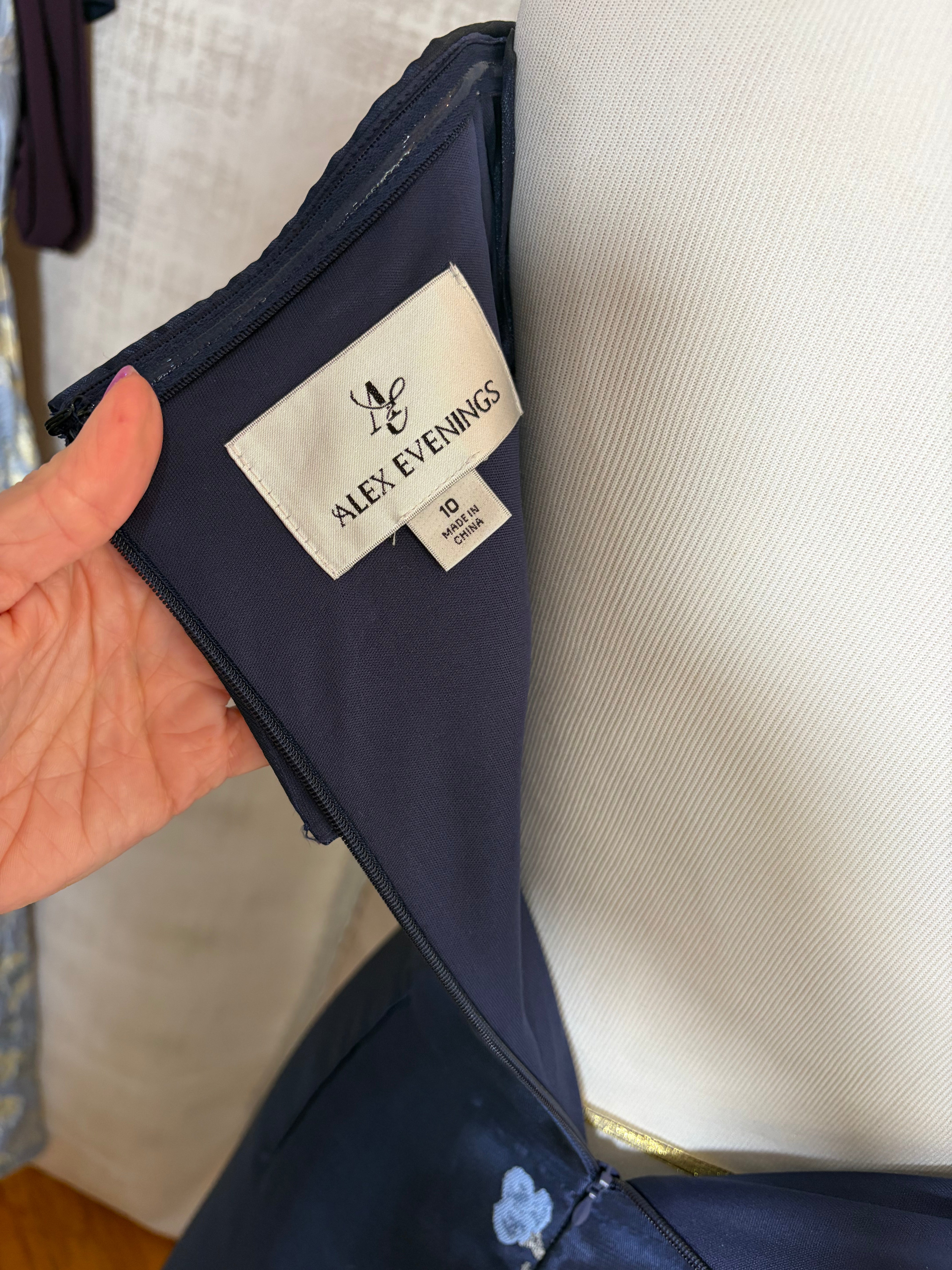 Navy floral off-shoulder A-line evening gown with V-neckline at Dover Grace Boutique in Watkinsville, Georgia.