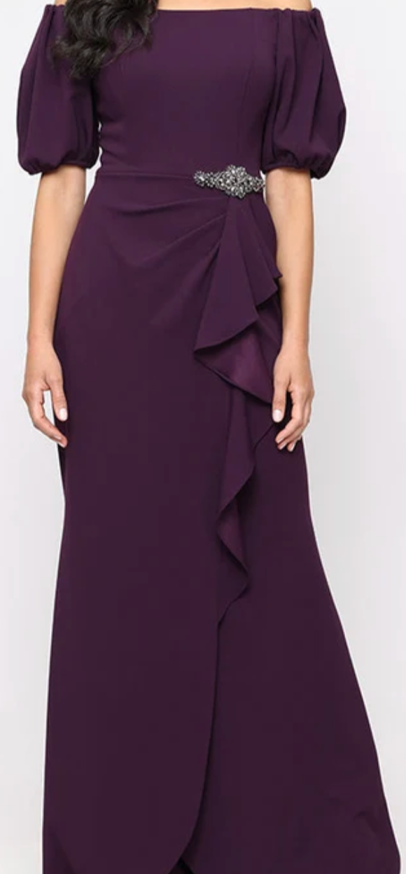 Plum off-shoulder stretch crepe sheath gown with beaded ruffle at Dover Grace Boutique in Watkinsville, Georgia.