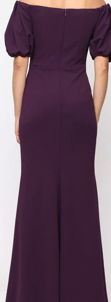 Plum off-shoulder stretch crepe sheath gown with beaded ruffle at Dover Grace Boutique in Watkinsville, Georgia.