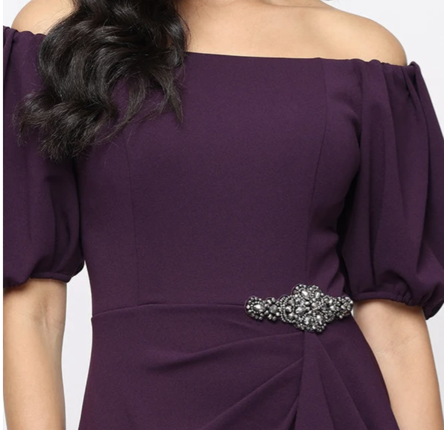 Plum off-shoulder stretch crepe sheath gown with beaded ruffle at Dover Grace Boutique in Watkinsville, Georgia.
