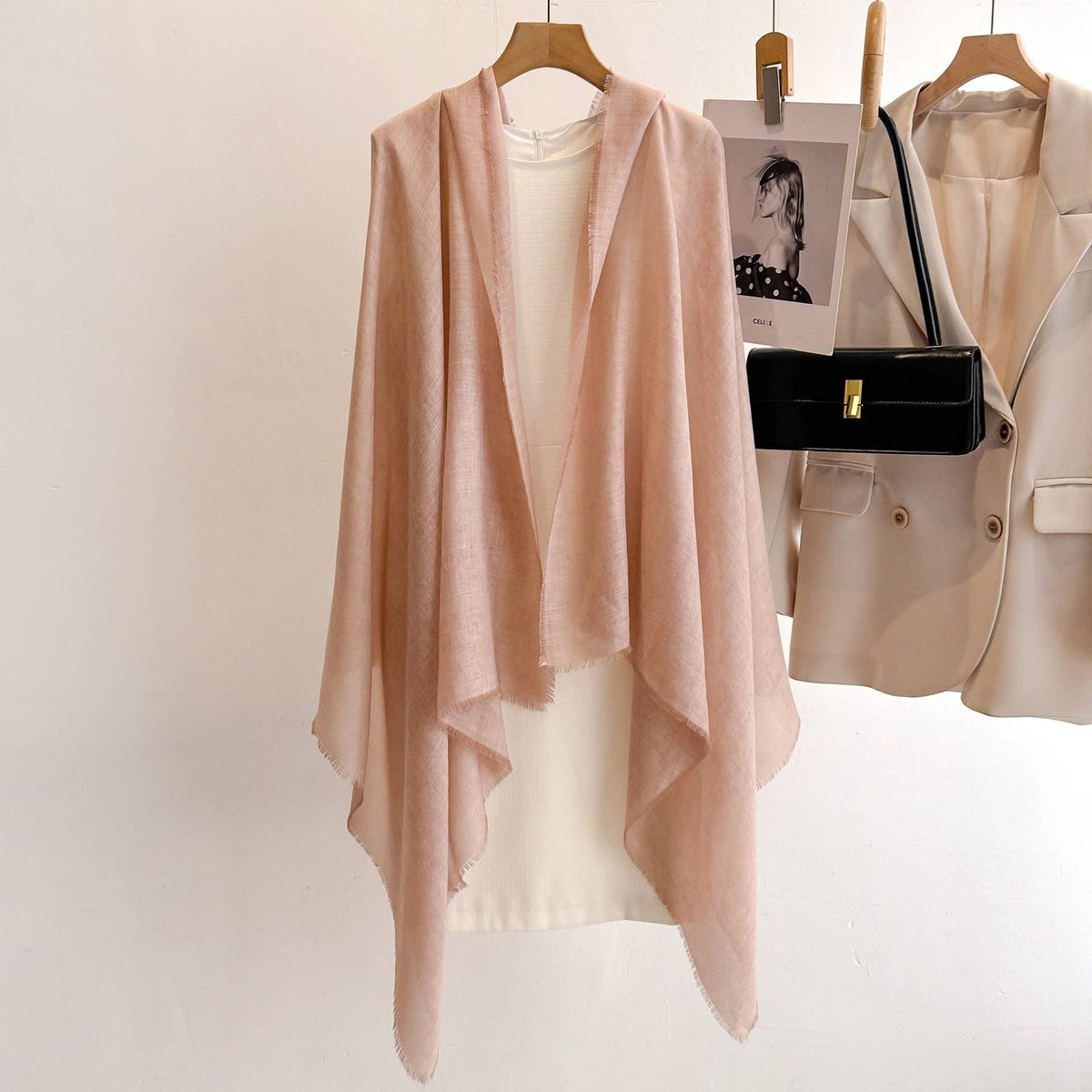 Dusty pink fringed scarf over a white outfit at Dover Grace Boutique in Watkinsville, Georgia.